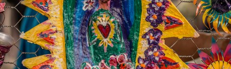 A colorful paper mache folk art piece depicting Saint Guadelopue, also known as the Virgin Mary