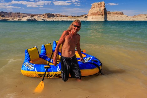 A man with his inflatable raft in Wahweap Bay, Utah