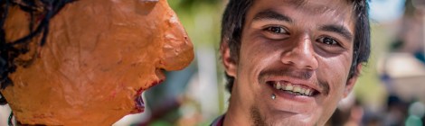 A young man and a papier mache puppet